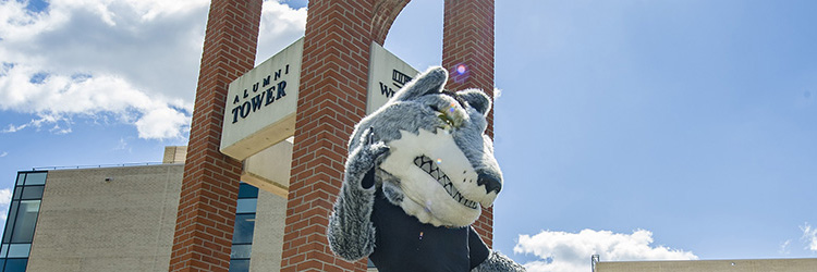photo of rowdy in front of alumni tower