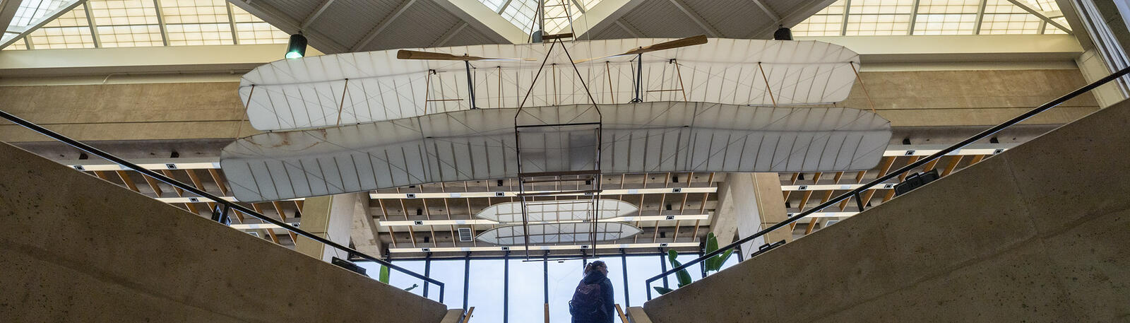 photo of a student walking up the stairway in dunbar library at wright state