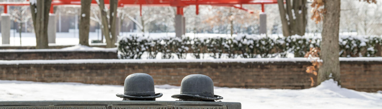 photo of the bench and wright brothers hats on wright state's campus 